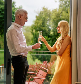 Couple toasting with prosecco on Studio Apartment balcony 