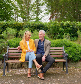 Couple seated on a bench enjoying a peaceful moment in Herbert Park